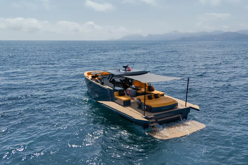 Gustavia I Yacht Photos Pics Luxury 2021 OKEAN 55 yacht cruising on open sea with scenic mountain backdrop.