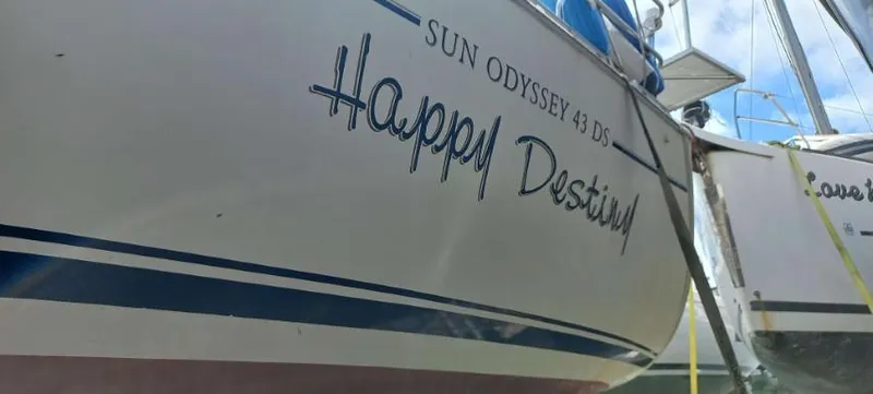 Happy Destiny Yacht Photos Pics 2004 Jeanneau Sun Odyssey 43 DS sailboat named "Happy Destiny" docked at a marina.