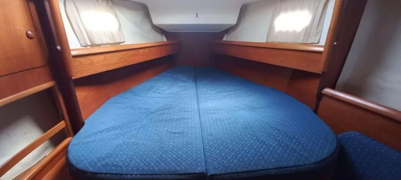 Happy Destiny Yacht Photos Pics Interior cabin of 2004 Jeanneau Sun Odyssey 43 DS with blue bedding.