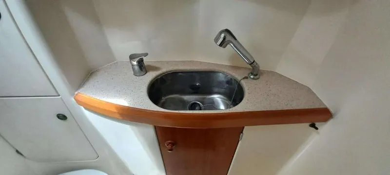 Happy Destiny Yacht Photos Pics Compact sink area in 2004 Jeanneau Sun Odyssey 43 DS yacht bathroom.