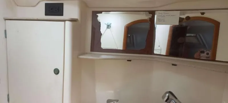 Happy Destiny Yacht Photos Pics Interior of 2004 Jeanneau Sun Odyssey 43 DS with broken mirror and cabinet.
