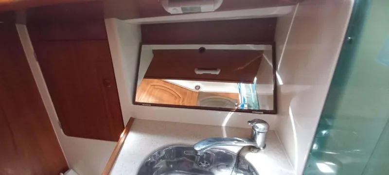 Happy Destiny Yacht Photos Pics Interior of 2004 Jeanneau Sun Odyssey 43 DS yacht bathroom with sink and mirror.