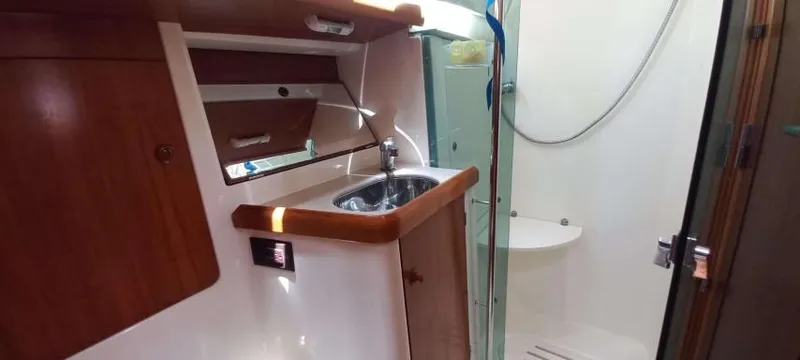 Happy Destiny Yacht Photos Pics Interior of 2004 Jeanneau Sun Odyssey 43 DS yacht, featuring a compact bathroom with sink and shower.