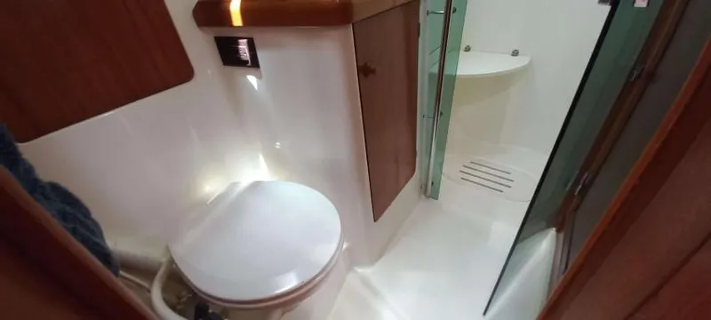 Happy Destiny Yacht Photos Pics Bathroom interior of 2004 Jeanneau Sun Odyssey 43 DS yacht, featuring toilet and shower.