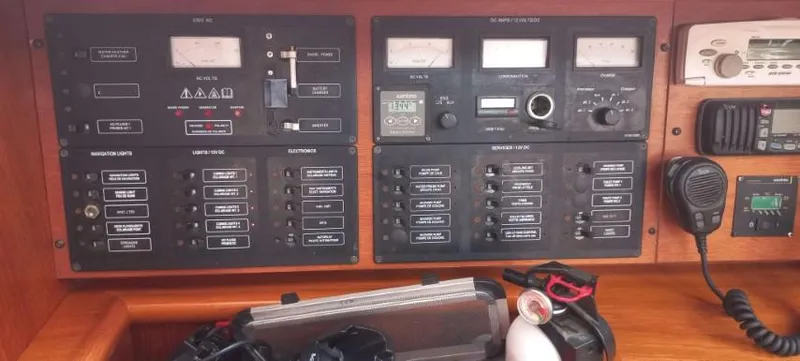 Happy Destiny Yacht Photos Pics Control panel of a 2004 Jeanneau Sun Odyssey 43 DS sailboat, featuring navigation and communication equipment.