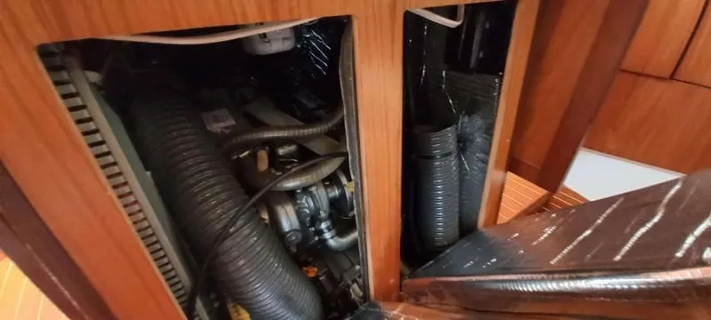 Happy Destiny Yacht Photos Pics Engine compartment of 2004 Jeanneau Sun Odyssey 43 DS sailboat, showcasing mechanical components.