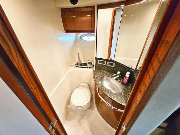 Yacht Photos Pics Luxurious bathroom in 2006 Sea Ray 44 Sundancer yacht with modern fixtures and wood accents.