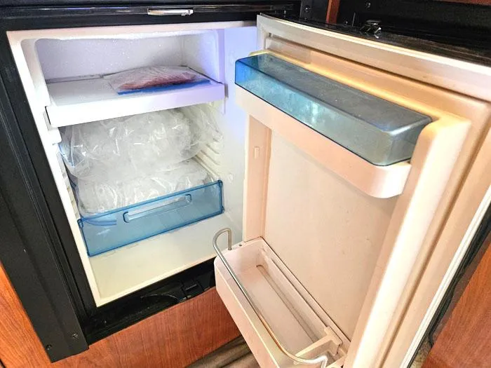  Yacht Photos Pics Open refrigerator inside 2006 Sea Ray 44 Sundancer yacht, showing shelves and storage compartments.