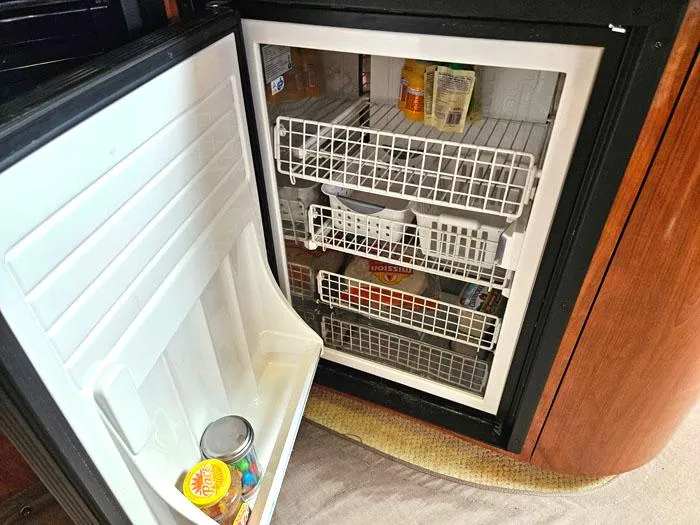  Yacht Photos Pics Open refrigerator on 2006 Sea Ray 44 Sundancer yacht, showing organized interior shelves.