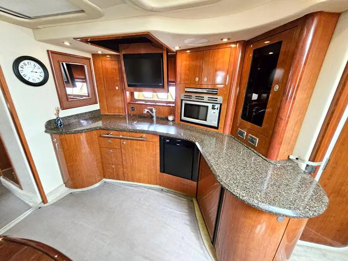  Yacht Photos Pics Luxurious kitchen interior of 2006 Sea Ray 44 Sundancer yacht with modern appliances.