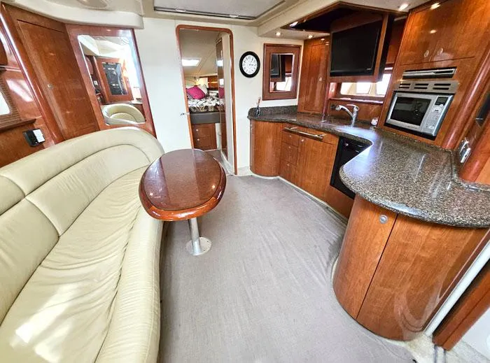  Yacht Photos Pics Luxurious interior of 2006 Sea Ray 44 Sundancer yacht with kitchen and seating area.