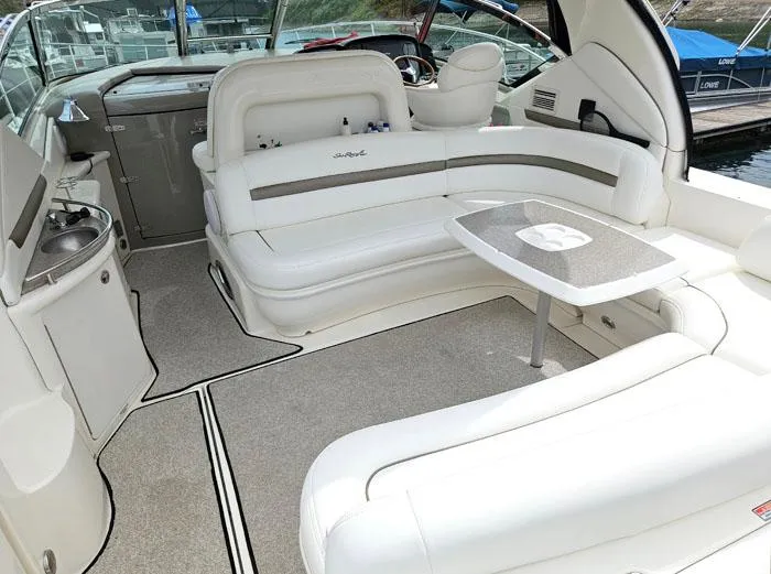  Yacht Photos Pics 2006 Sea Ray 44 Sundancer interior with white seating and table, docked at marina.