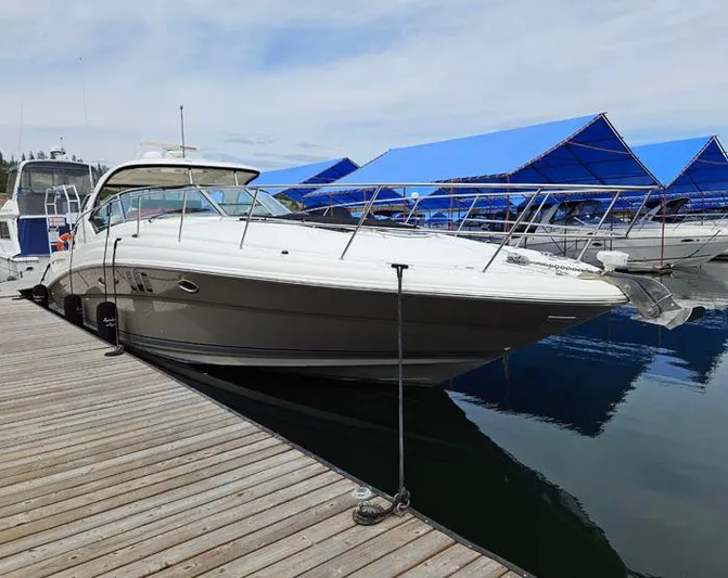  Yacht Photos Pics 2006 Sea Ray 44 Sundancer yacht docked at marina with blue canopies.