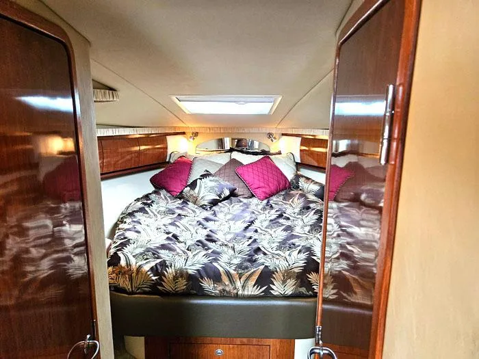  Yacht Photos Pics Luxurious cabin interior of 2006 Sea Ray 44 Sundancer with plush bedding and elegant wood finishes.