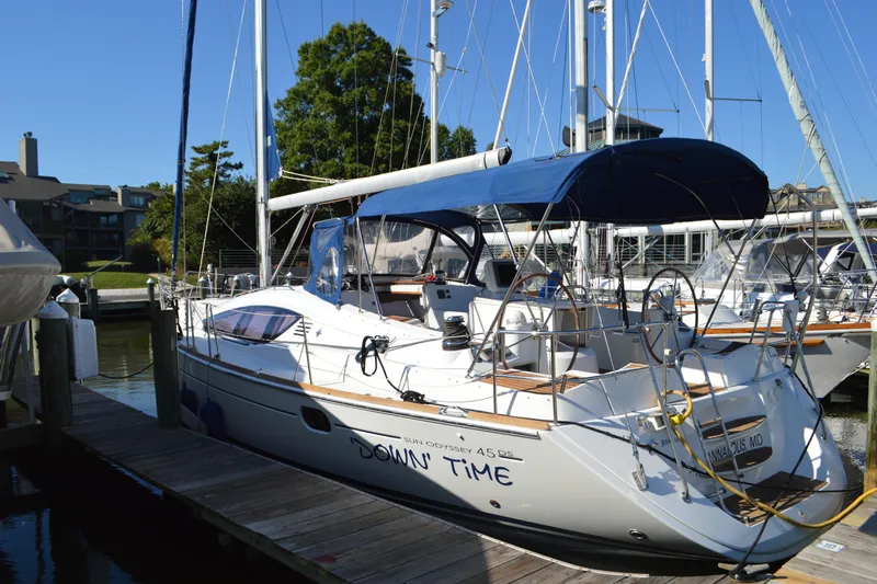 Down Time Yacht Photos Pics 2008 Jeanneau Sun Odyssey 45 DS sailboat docked, featuring blue canopy and sleek design.