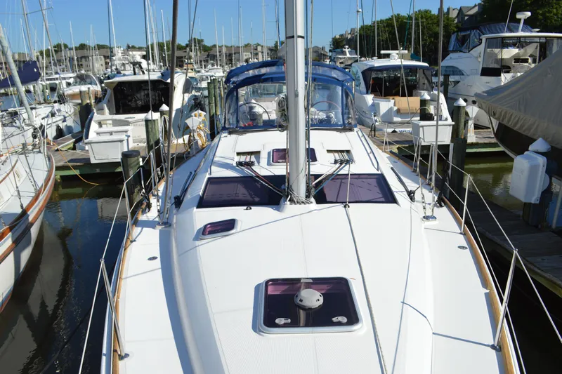 Down Time Yacht Photos Pics 2008 Jeanneau Sun Odyssey 45 DS sailboat docked in a marina, surrounded by other boats.