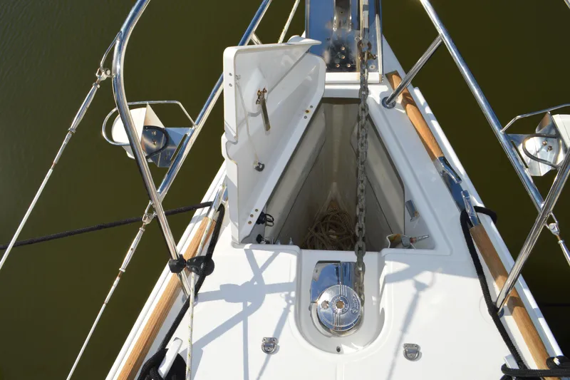 Down Time Yacht Photos Pics Bow of 2008 Jeanneau Sun Odyssey 45 DS sailboat with anchor chain and open hatch.