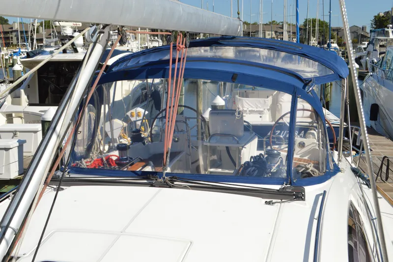 Down Time Yacht Photos Pics 2008 Jeanneau Sun Odyssey 45 DS sailboat docked at marina, featuring blue canopy.