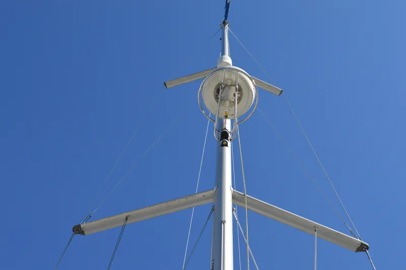Down Time Yacht Photos Pics Mast of 2008 Jeanneau Sun Odyssey 45 DS sailboat against clear blue sky.
