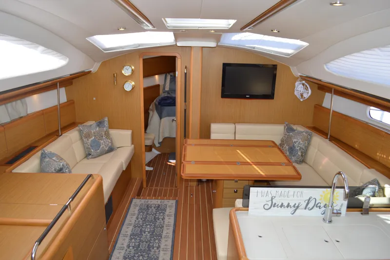 Down Time Yacht Photos Pics Luxurious interior of 2008 Jeanneau Sun Odyssey 45 DS sailboat with elegant wood finish.