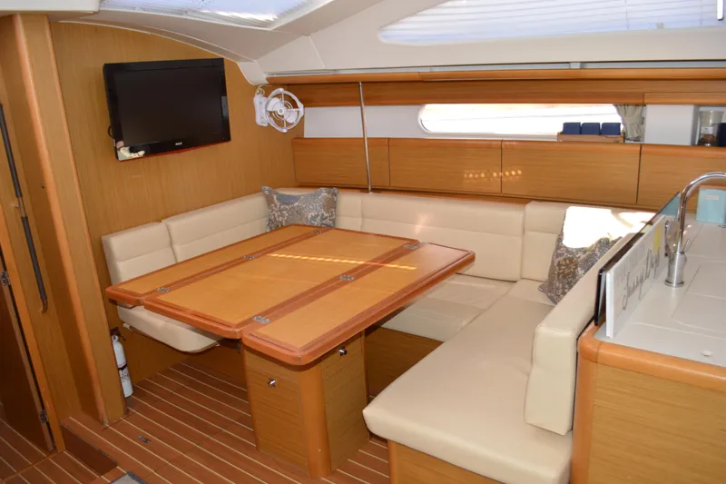 Down Time Yacht Photos Pics Interior of 2008 Jeanneau Sun Odyssey 45 DS yacht with dining area and TV.
