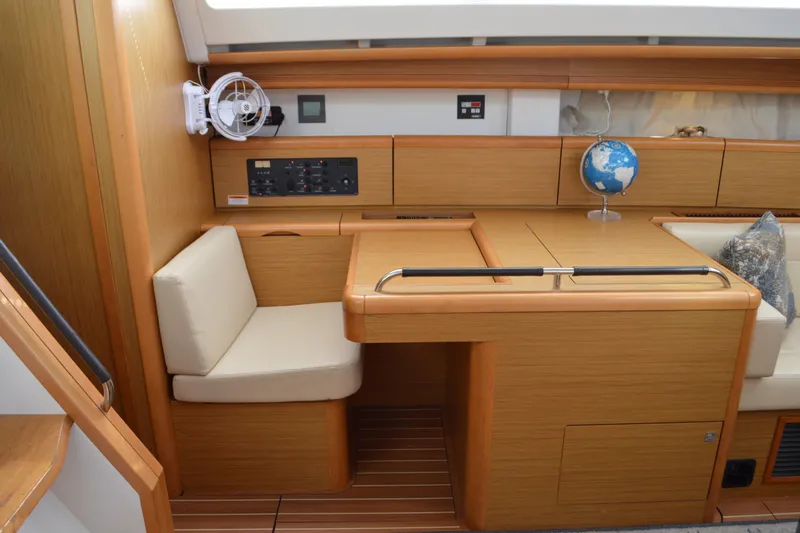 Down Time Yacht Photos Pics Interior of 2008 Jeanneau Sun Odyssey 45 DS yacht with wooden finish and seating area.