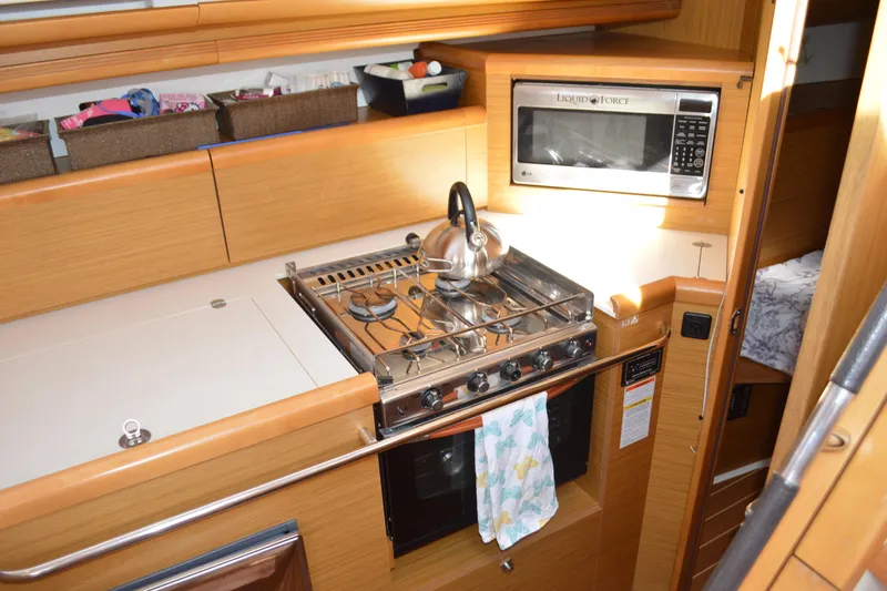 Down Time Yacht Photos Pics Galley kitchen in 2008 Jeanneau Sun Odyssey 45 DS yacht with stove and microwave.