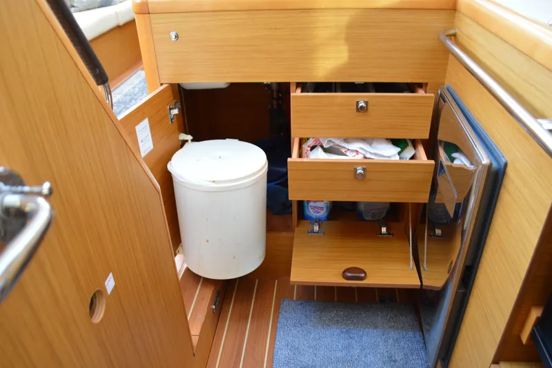 Down Time Yacht Photos Pics Interior of 2008 Jeanneau Sun Odyssey 45 DS yacht with wooden cabinetry and storage drawers.