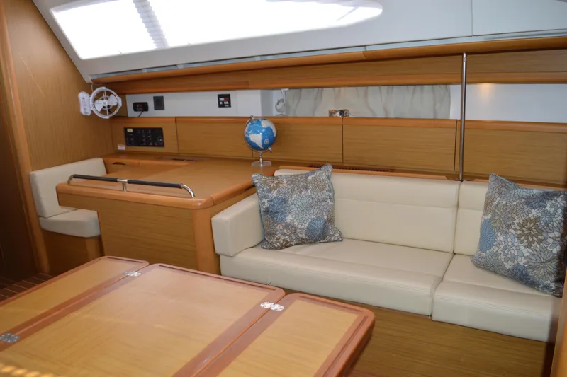 Down Time Yacht Photos Pics Interior of 2008 Jeanneau Sun Odyssey 45 DS yacht with beige seating and wooden accents.