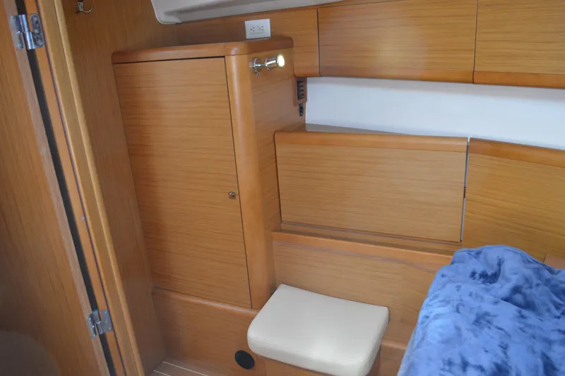 Down Time Yacht Photos Pics Interior of 2008 Jeanneau Sun Odyssey 45 DS, featuring wooden cabinetry and seating.
