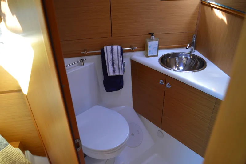 Down Time Yacht Photos Pics Bathroom interior of 2008 Jeanneau Sun Odyssey 45 DS yacht, featuring sink and toilet.