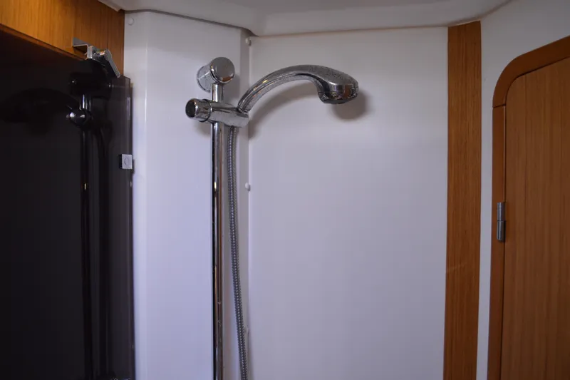 Down Time Yacht Photos Pics Shower area in 2008 Jeanneau Sun Odyssey 45 DS yacht, featuring sleek chrome fixtures.