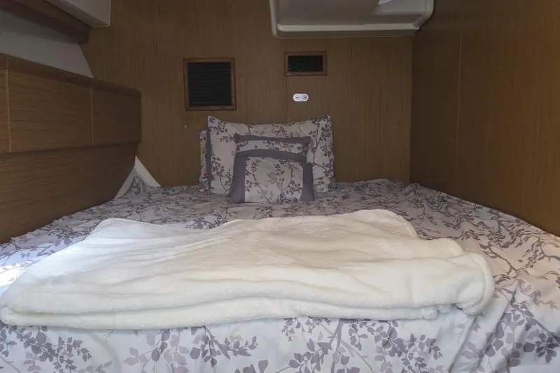 Down Time Yacht Photos Pics Cozy cabin interior of 2008 Jeanneau Sun Odyssey 45 DS with floral bedding.
