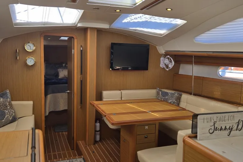 Down Time Yacht Photos Pics Luxurious interior of 2008 Jeanneau Sun Odyssey 45 DS sailboat with elegant wood finish.