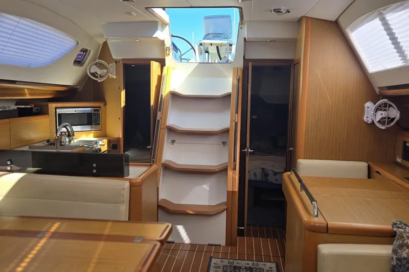 Down Time Yacht Photos Pics Interior of 2008 Jeanneau Sun Odyssey 45 DS yacht with modern kitchen and seating area.