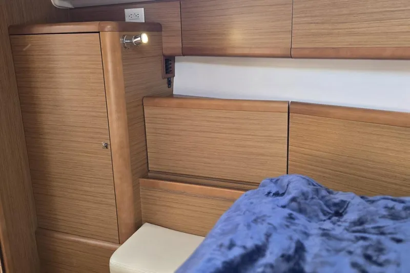 Down Time Yacht Photos Pics Interior cabin of 2008 Jeanneau Sun Odyssey 45 DS with wooden finish and cozy seating.