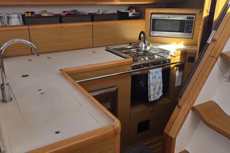 Down Time Yacht Photos Pics Galley kitchen in 2008 Jeanneau Sun Odyssey 45 DS sailboat with stove and microwave.