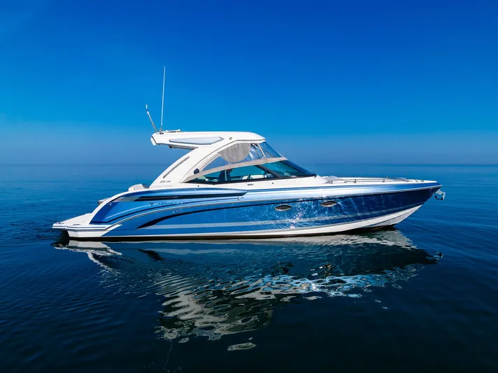 Good Morning Sunshine Yacht Photos Pics 2019 Formula 330 Crossover Bowrider on calm blue water under clear sky.
