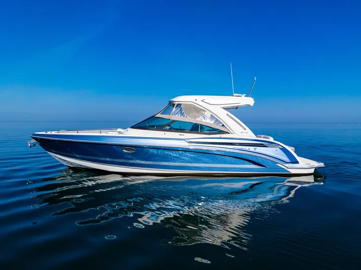 Good Morning Sunshine Yacht Photos Pics 2019 Formula 330 Crossover Bowrider on calm blue water under clear sky.