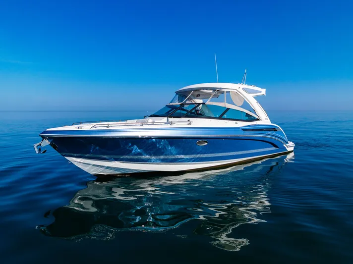 Good Morning Sunshine Yacht Photos Pics 2019 Formula 330 Crossover Bowrider on calm blue water under clear sky.