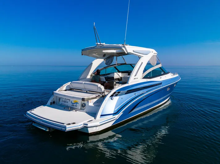 Good Morning Sunshine Yacht Photos Pics 2019 Formula 330 Crossover Bowrider on calm blue water, showcasing sleek design and luxury features.