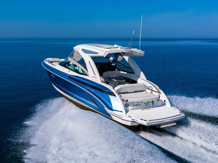 Good Morning Sunshine Yacht Photos Pics 2019 Formula 330 Crossover Bowrider cruising on open water, showcasing sleek design and performance.
