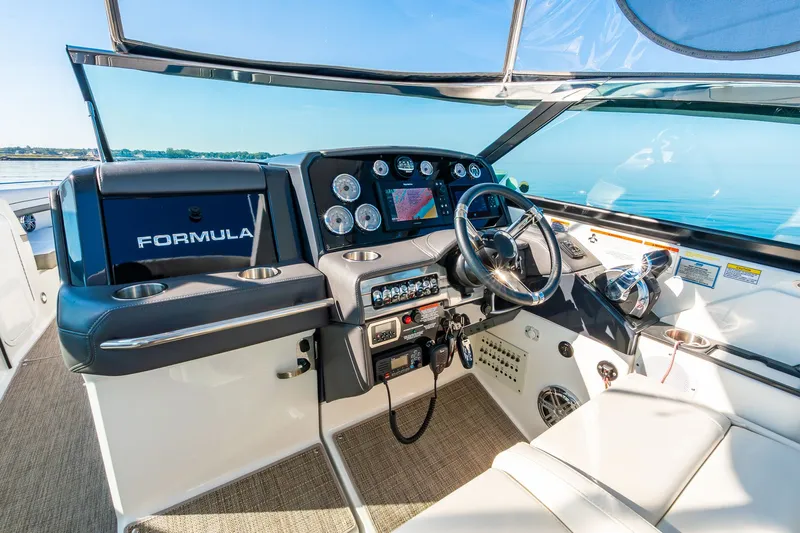 Good Morning Sunshine Yacht Photos Pics 2019 Formula 330 Crossover Bowrider cockpit with modern controls and navigation system.