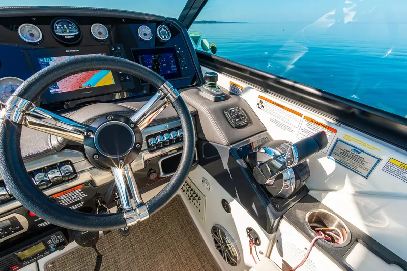Good Morning Sunshine Yacht Photos Pics Cockpit of 2019 Formula 330 Crossover Bowrider with steering wheel and navigation controls.
