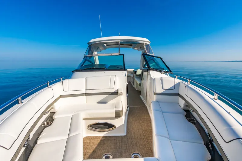 Good Morning Sunshine Yacht Photos Pics 2019 Formula 330 Crossover Bowrider on calm blue water, featuring spacious seating and sleek design.