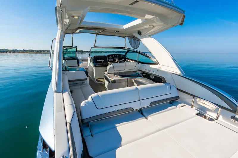 Good Morning Sunshine Yacht Photos Pics 2019 Formula 330 Crossover Bowrider on calm water, showcasing luxurious seating and sleek design.