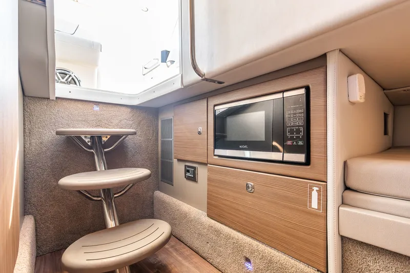 Good Morning Sunshine Yacht Photos Pics 2019 Formula 330 Crossover Bowrider interior with microwave and modern design.
