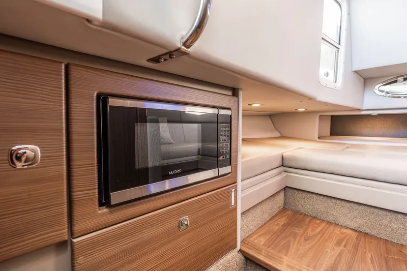Good Morning Sunshine Yacht Photos Pics 2019 Formula 330 Crossover Bowrider interior with microwave and cozy seating area.