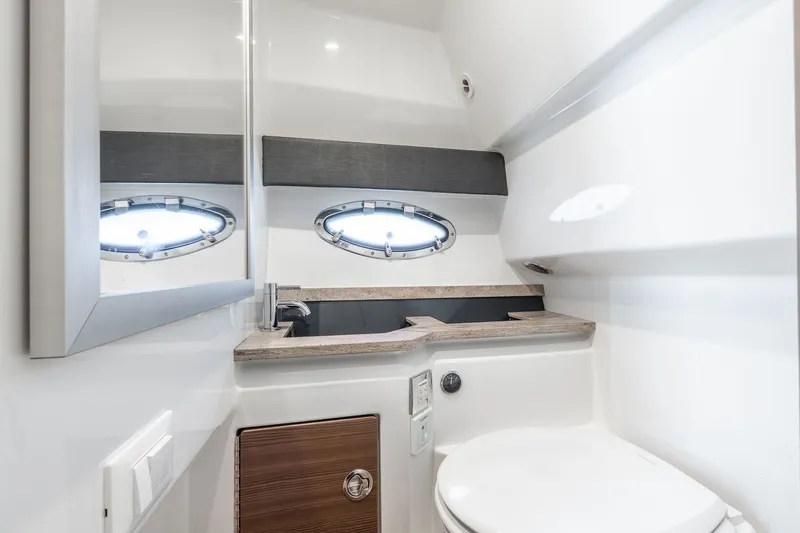 Good Morning Sunshine Yacht Photos Pics 2019 Formula 330 Crossover Bowrider bathroom with modern sink and porthole windows.
