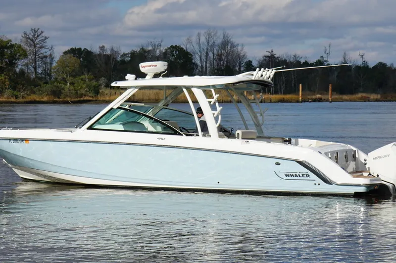  Yacht Photos Pics 2021 Boston Whaler 320 Vantage boat on calm water, side view.